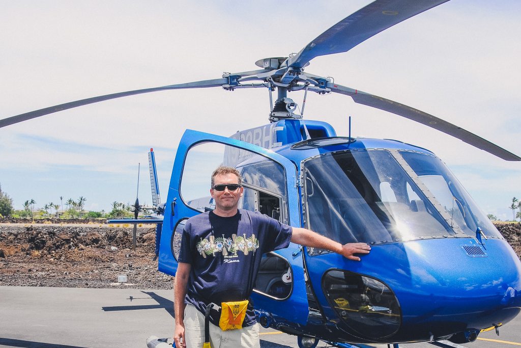 man standing next to helicopter in Hawaii