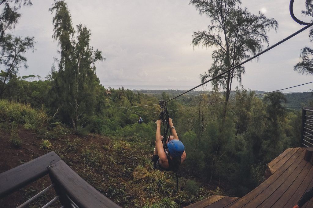 Climb Works in Hawaii, girl ziplines down the course 