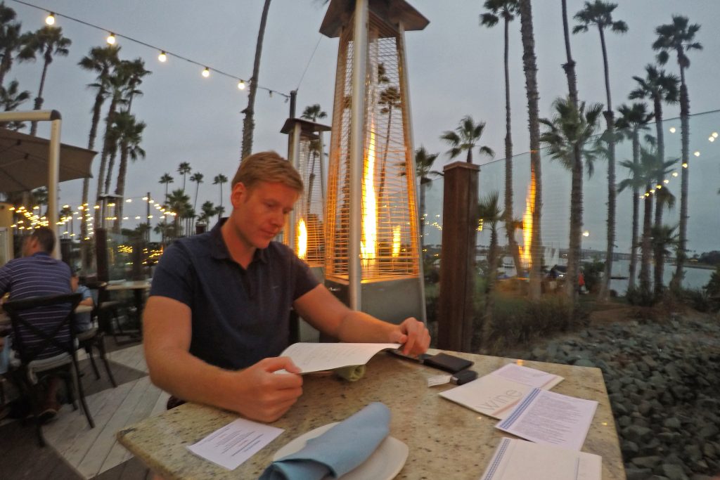 Man looking at menu at Tidal restaurant in San Diego