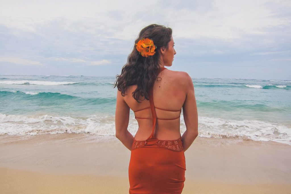 woman looks out onto water oahu Hawaii