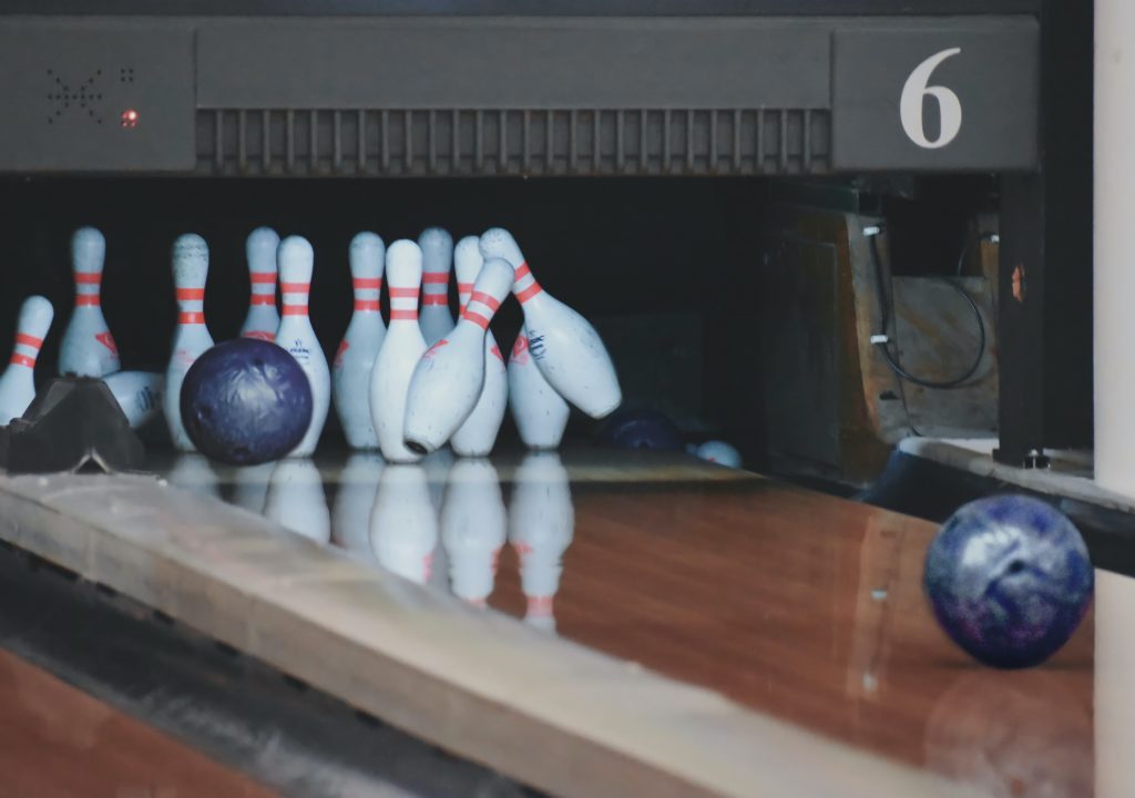 bowling pins being hit by bowling ball