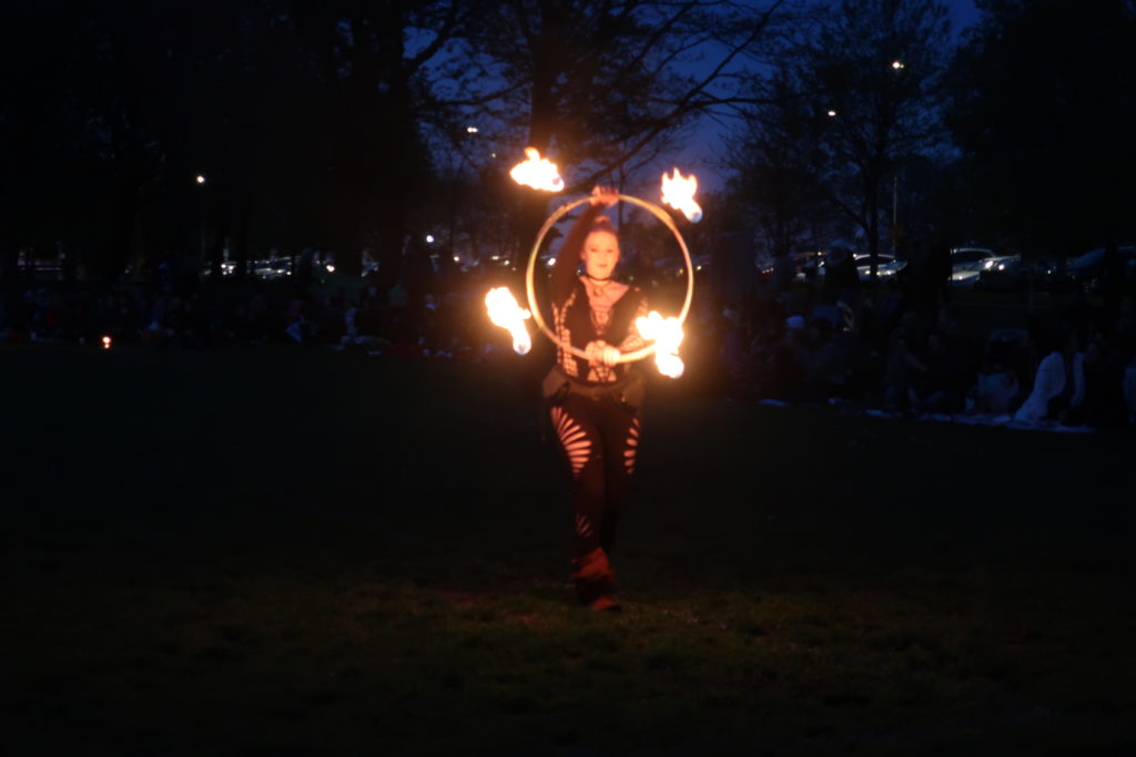 woman performing fire dance with hoop