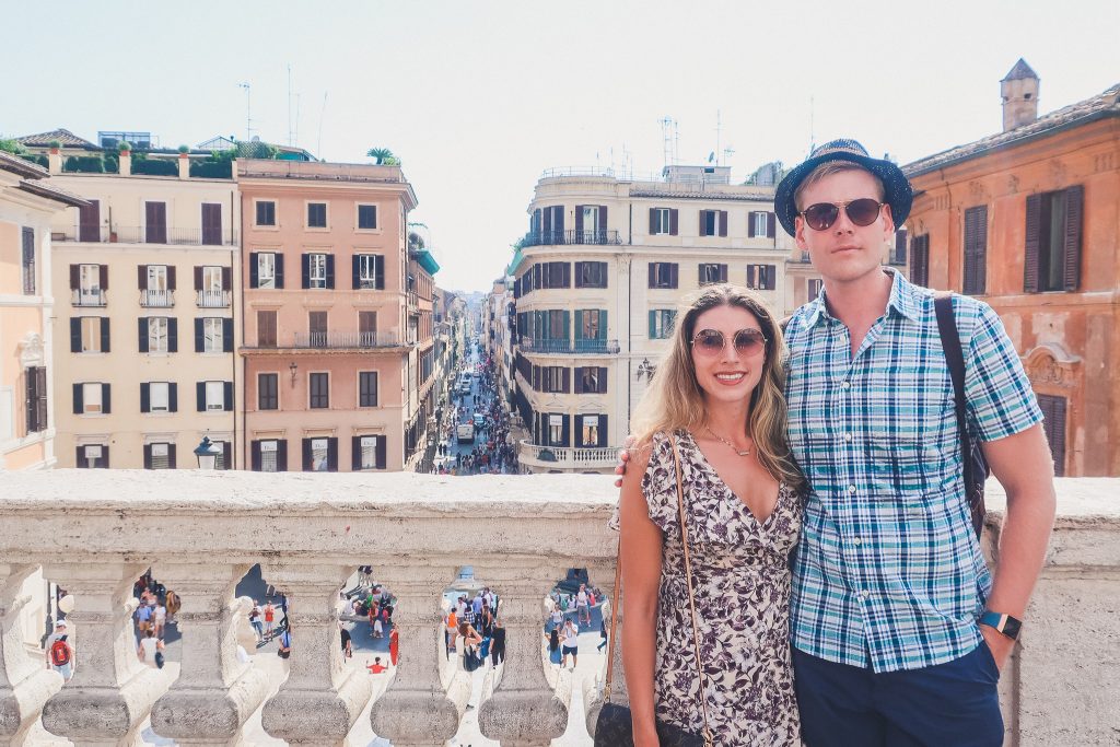 Couple stands at the top of the Spanish Steps in Rome