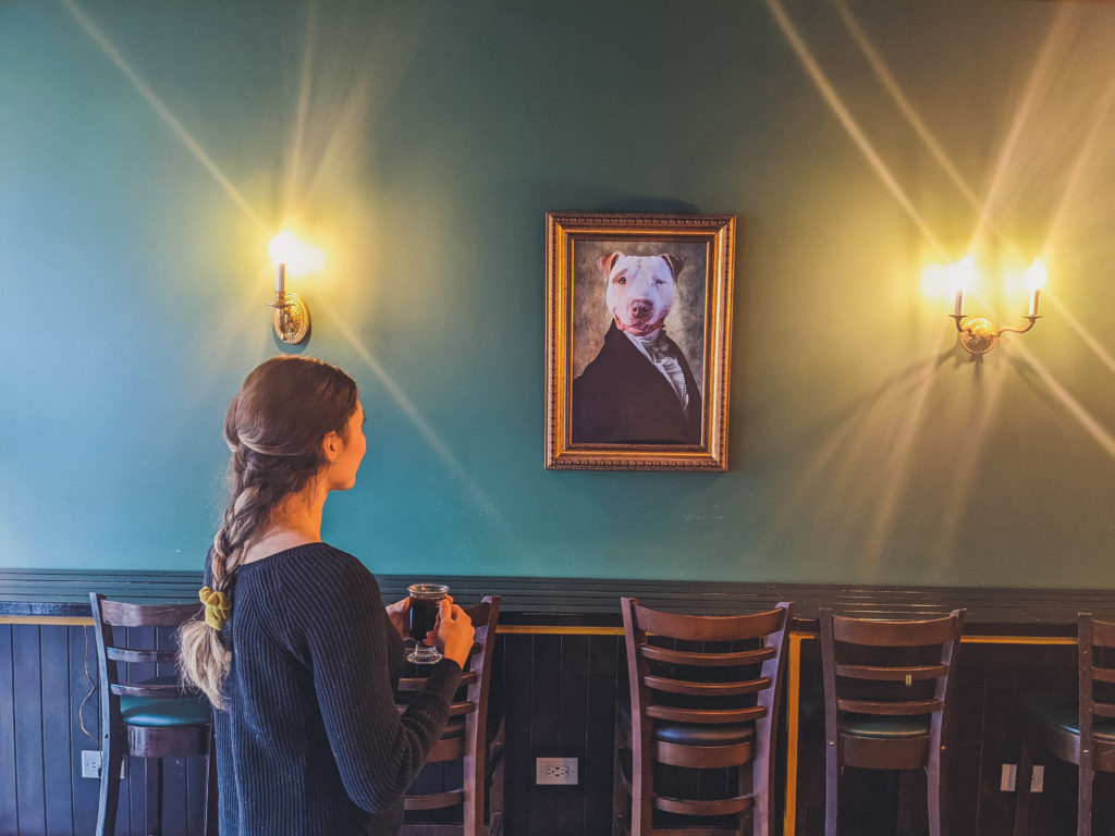 woman admires dog portrait at Ludlow Charlingtons in Lincoln Park