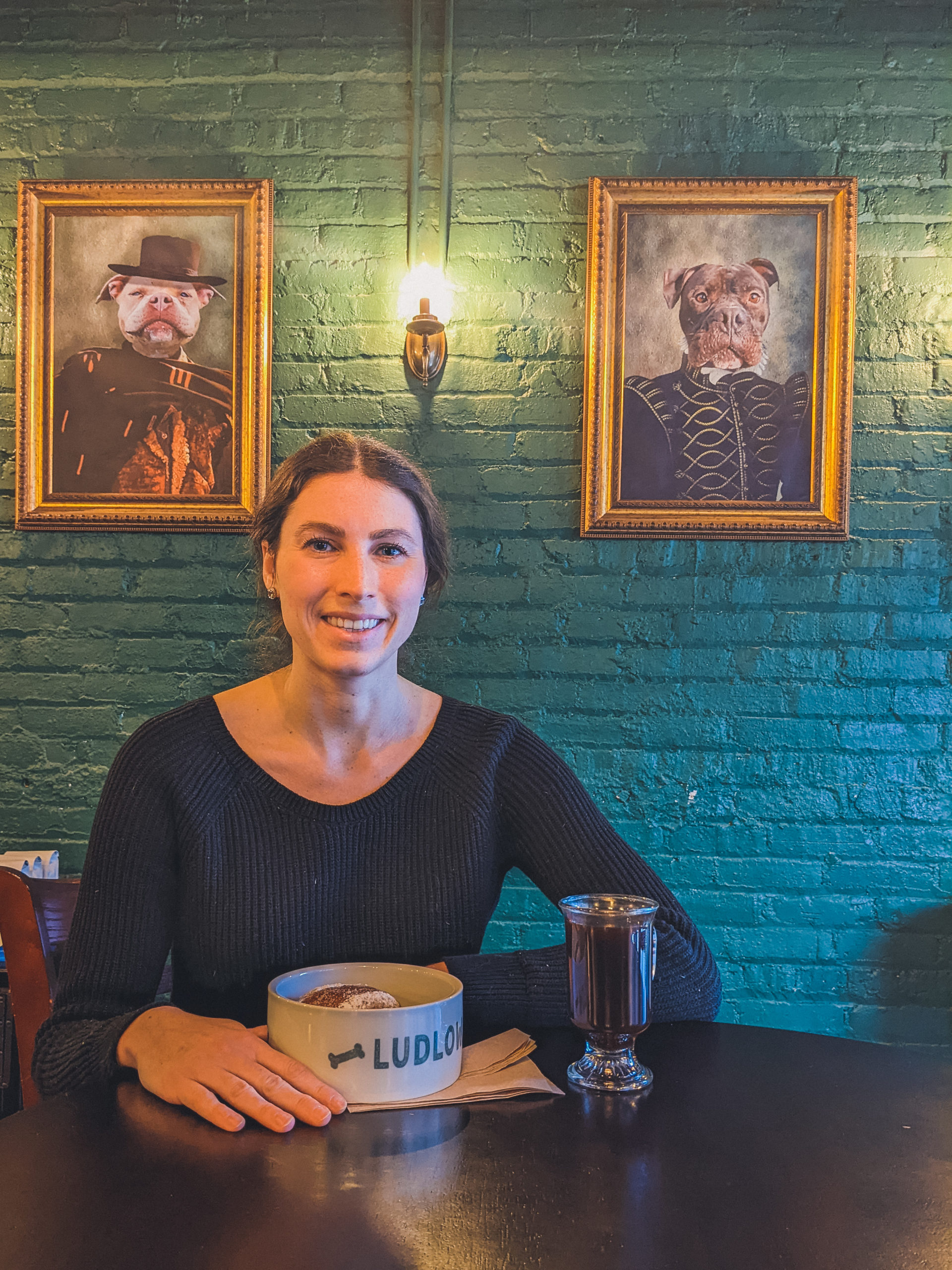 woman enjoys pastry and coffee at Ludlow Charlingtons in Chicago 