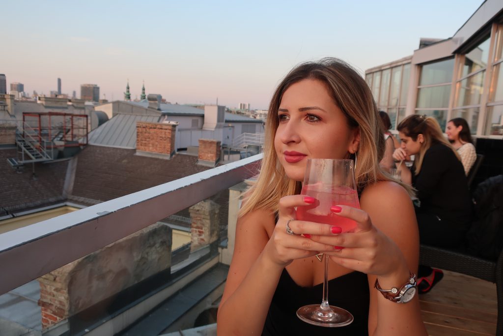 woman sips cocktail at Sky Bar in Vienna