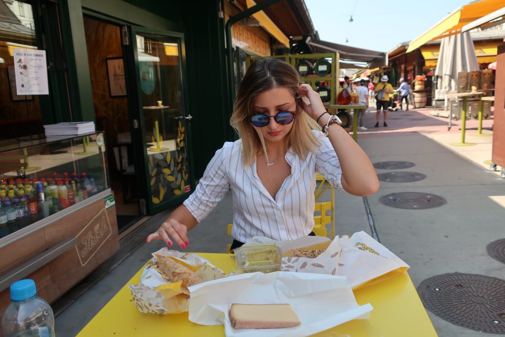 woman eats food at Nashmarket in Vienna 