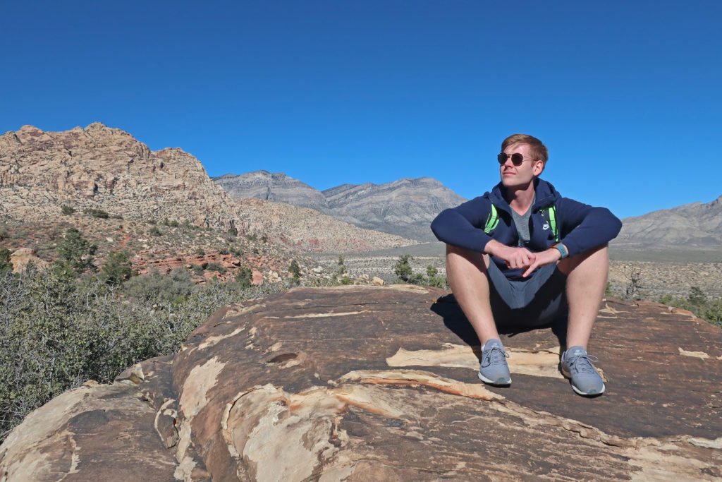 man sits on rock at Red Rock Canyon outside of Las Vegas