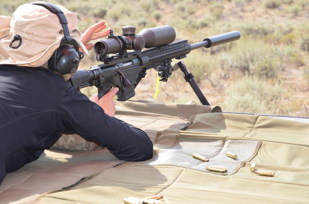 man takes aim at outdoor shooting range with sniper 