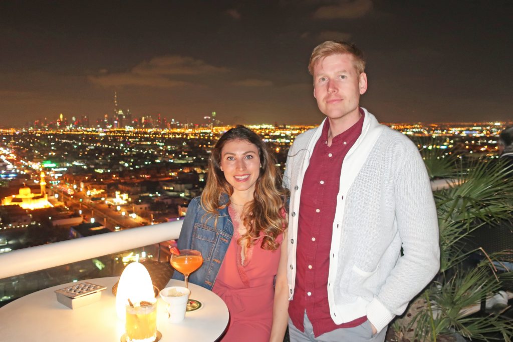 couple smiling at the camera from Uptown Bar in Dubai