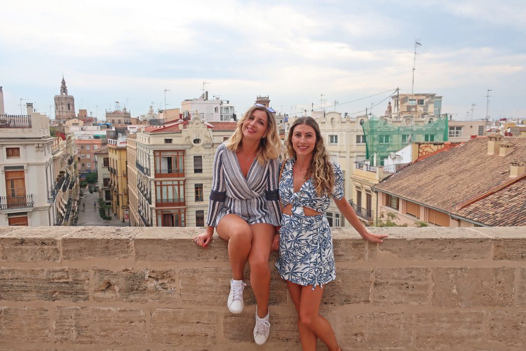 Two Girls standing in the Torres de Serranos, with Valencia City rooftops in the background