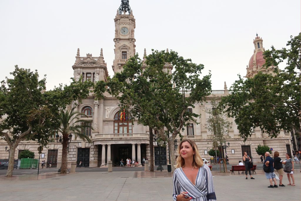 Girl standing in front of Valentina City Hall smiling