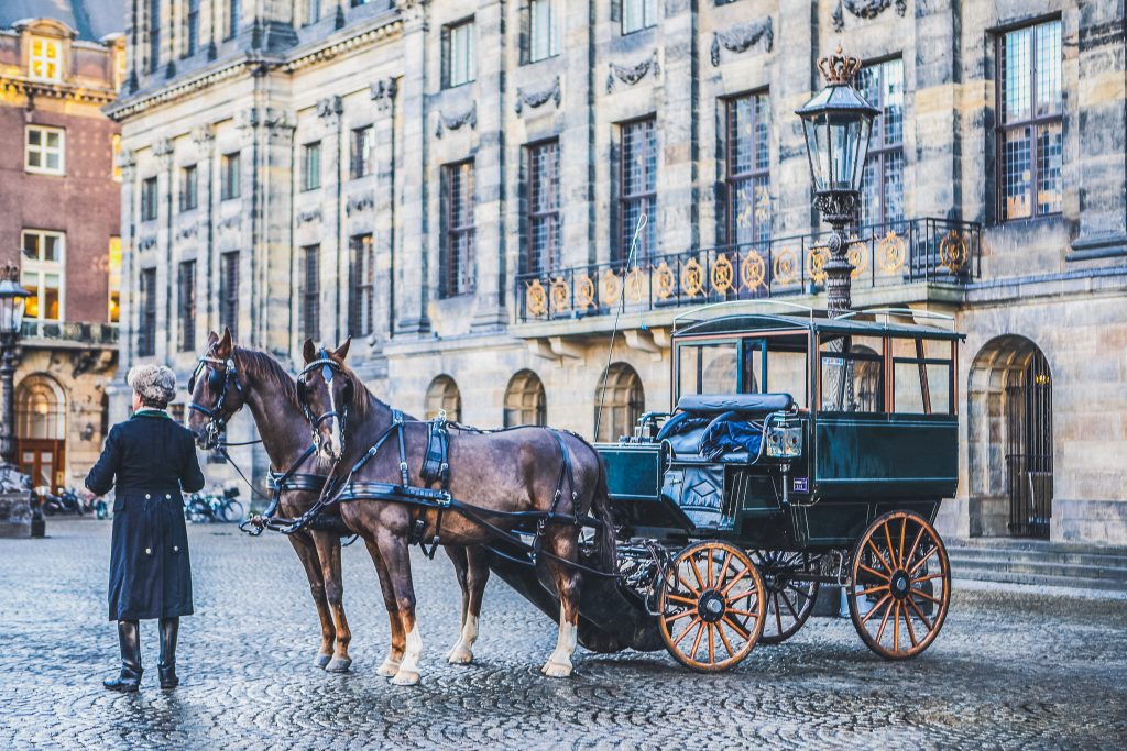 Carriage with horses on the central square of Amsterdam. on December 17, 2016 in Amsterdam - Netherlands.