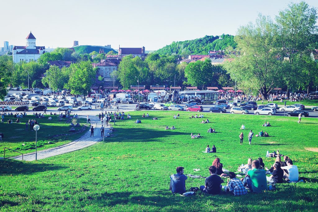 19, 2017: Young people sitting on the grass while celebration the Open Kitchen food festival in Vilnius, Lithuania.