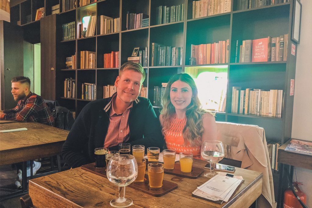 couple with flights at the beer library in Vilnius