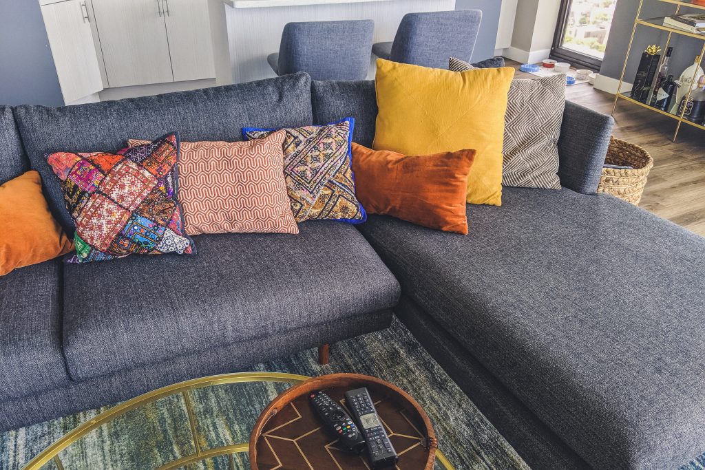 living room with boho pillow cases on couch