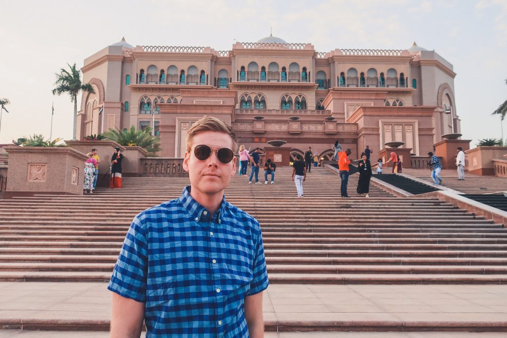 man standing in front of emirates palace