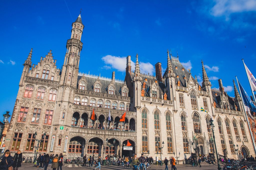 BRUGES, BELGIUM - MARCH, 2018: Provincial Court and Historium Bruges buildings on the market place