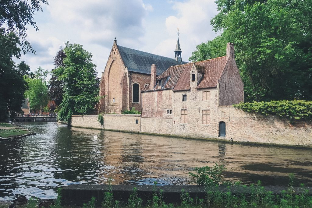 romantic castle building on the lake of love in bruges