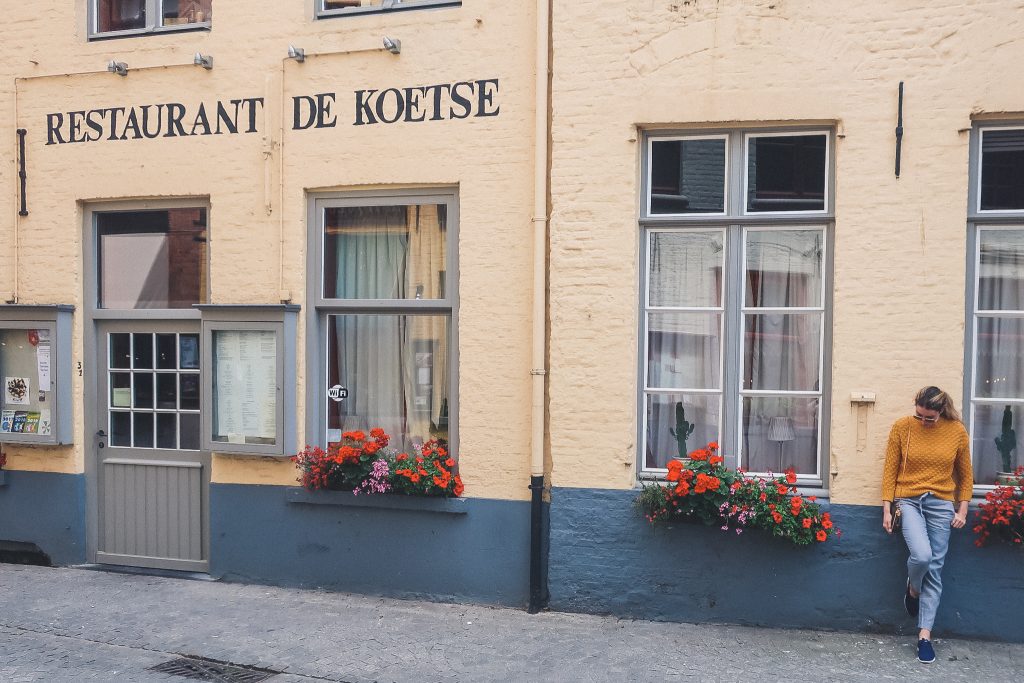 Girl standing in front of restaurant in Bruges