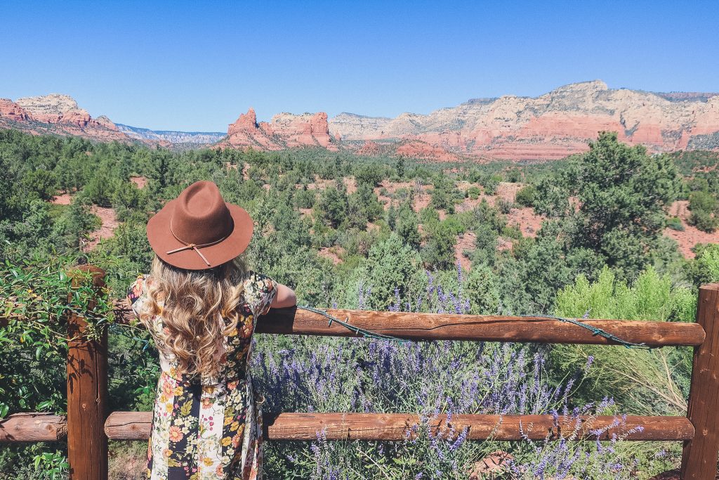 Girl looks out at Sedona Red Rocks from Mariposa Grill