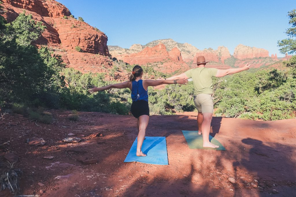 couple does yoga in Sedona near the Sugarloaf trail