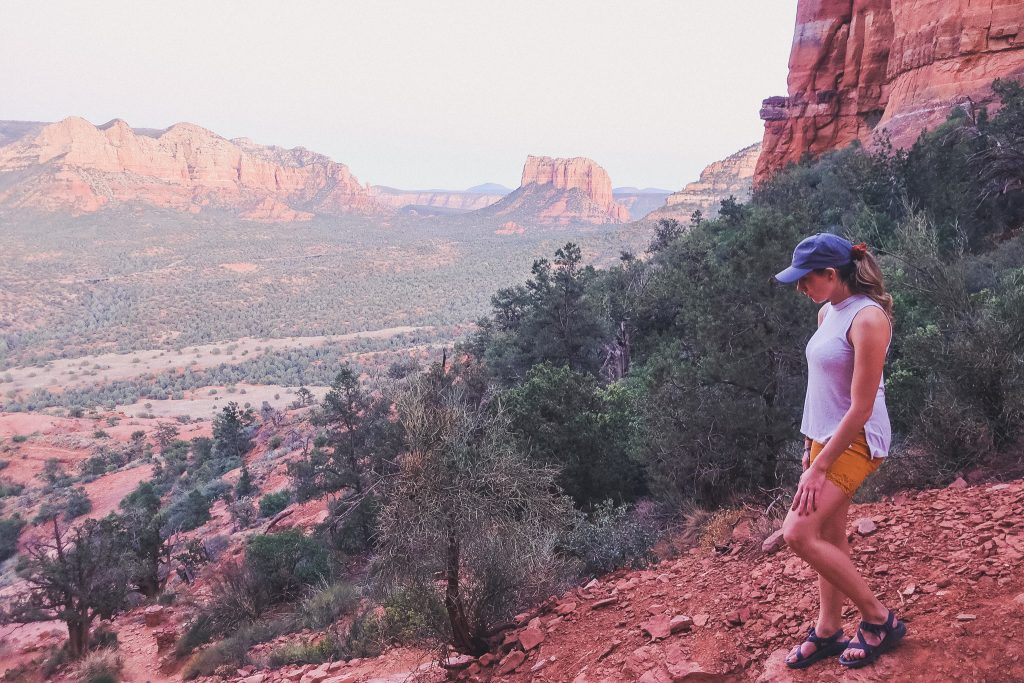 Girl hikes along Sedona trail at sunset