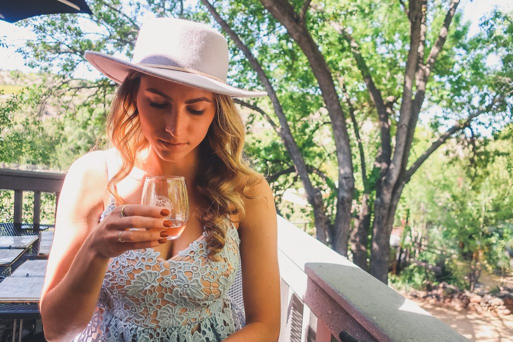 Girl looks on to glass of wine in Sedona winery