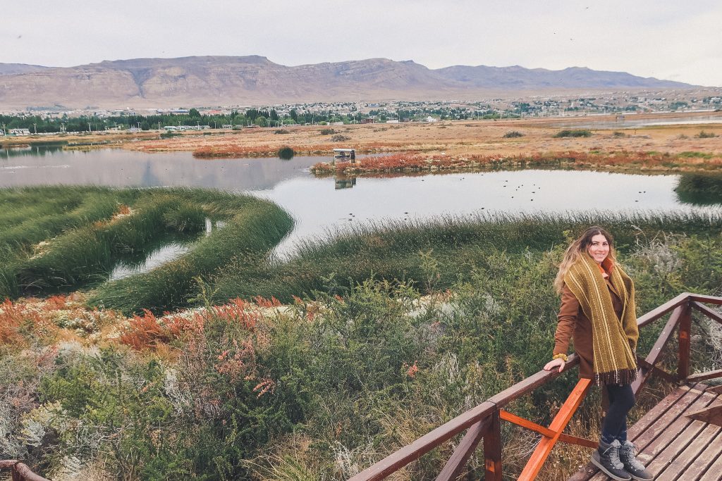 girl explores Laguna Nimez Reserve wearing wool blanket scarf