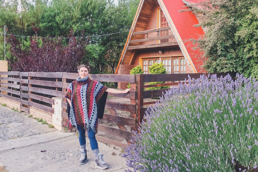 girl wears poncho in El Calafate downtown