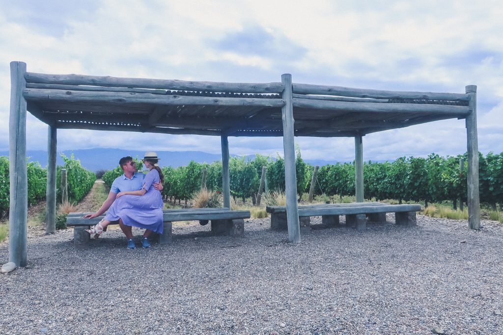 couple sits in vineyards in Uco Valley