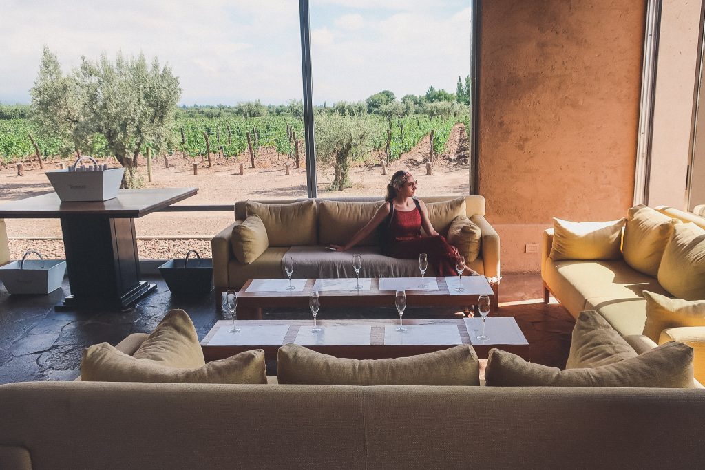 woman sits in tasting room at Vistalba