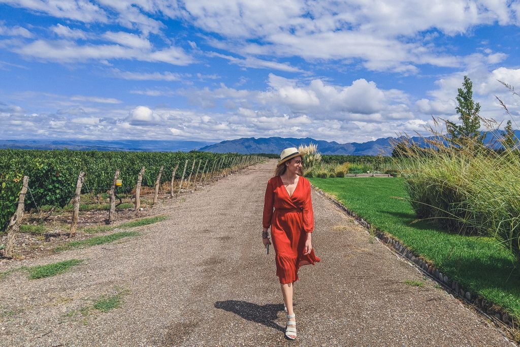 girl walking through vineyards in Luja de Cuyo