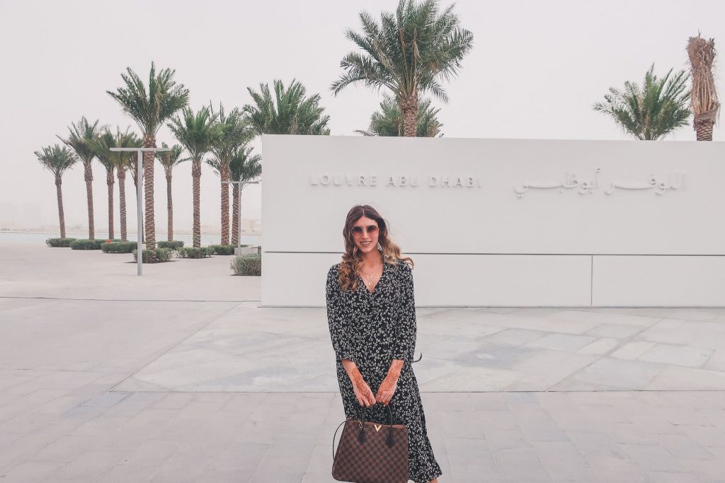 woman wears Louis Vuitton purse to the louvre abu dhabi