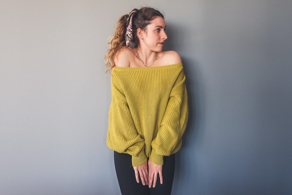 woman wears oversized knit sweater