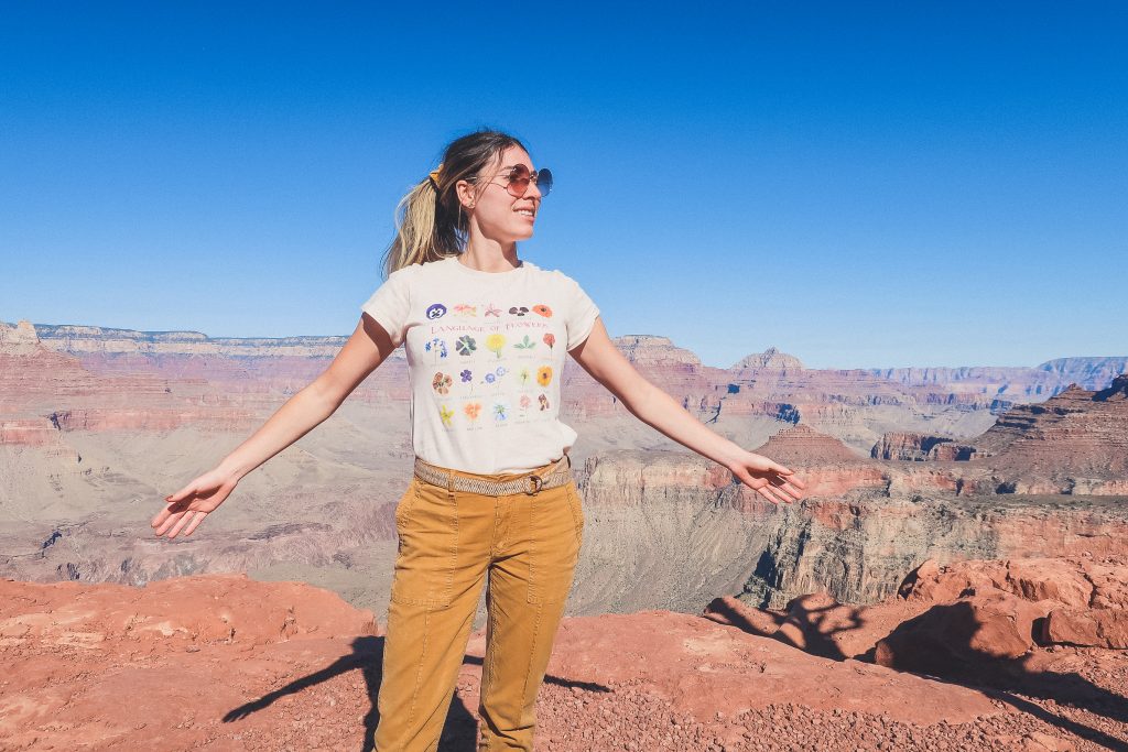 woman wears graphic tee with flowers at the Grand Canyon