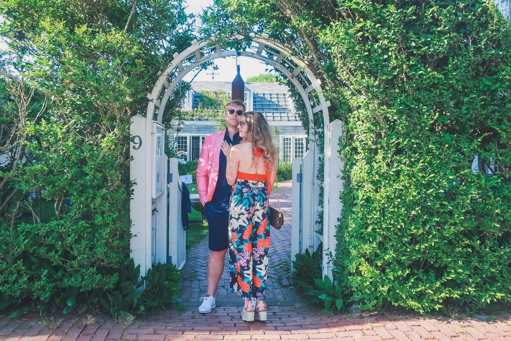 couple stands outside the garden at the The Chanticleer Nantucket