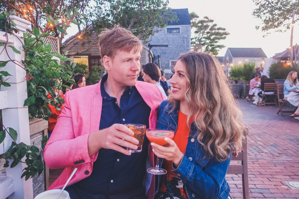 couple says cheers with drinks at Cru Nantucket