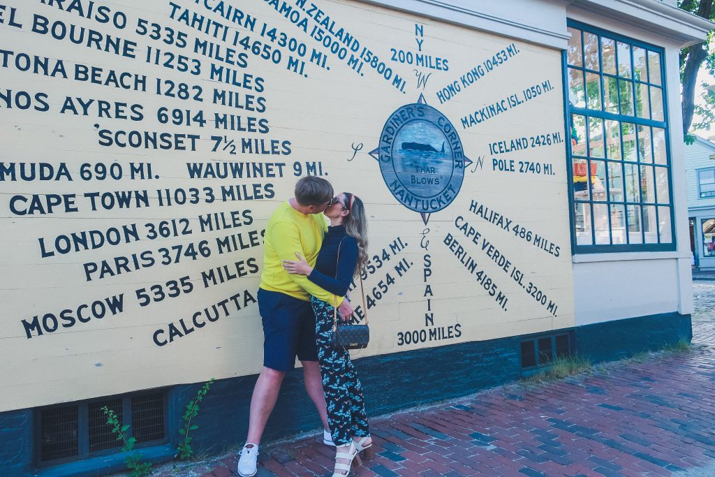 couple kisses at compass rose in Nantucket