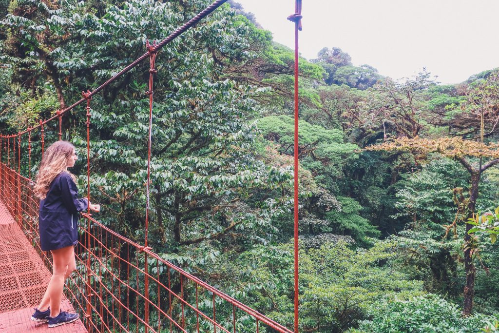 woman wears raincoat in Costa Rica rainforest