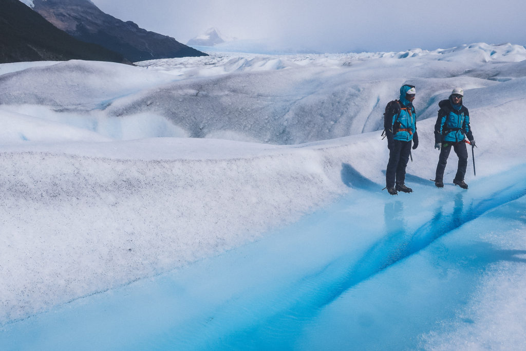 instructors examine a crevasse on Perito Moreno glacier 