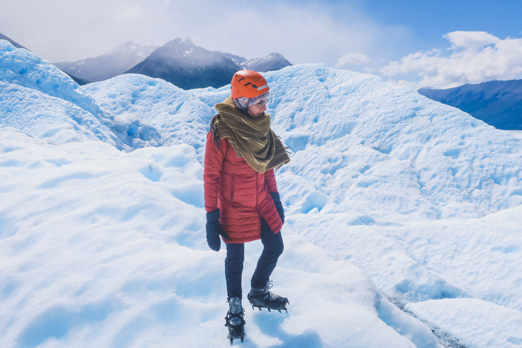 woman treks across the Perito Moreno glacier, very snowy conditions