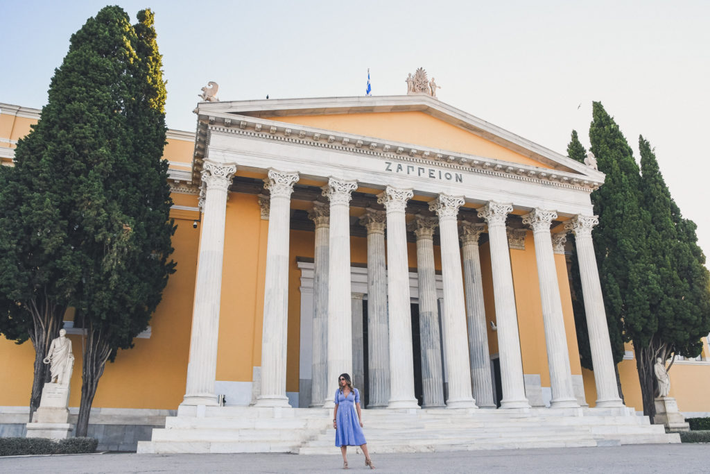 woman stands near Zappeion Hall in the National Garden in Athens 