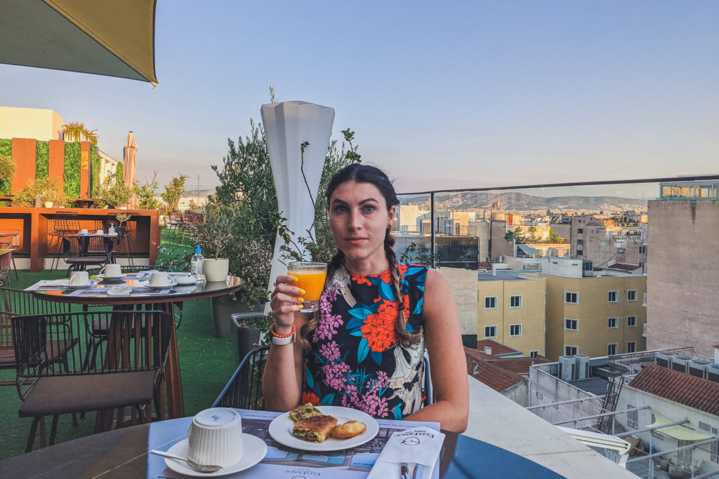 woman enjoys breakfast at Hotel Elia Ermou Athens on the rooftop